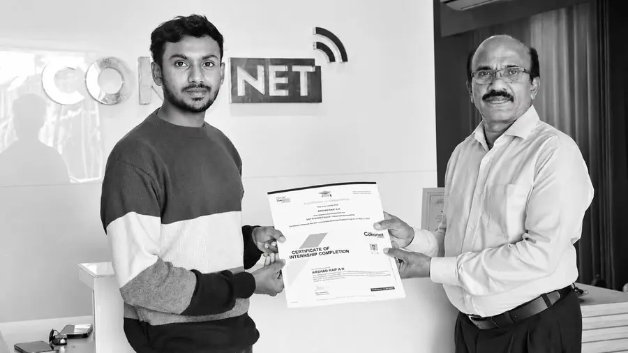 A learner receiving his course certificate from the trainer